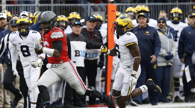 Ohio State quarterback J.T. Barrett plays against Michigan in an NCAA college football game Saturday, Nov. 26, 2016, in Columbus, Ohio. (AP Photo/Jay LaPrete)