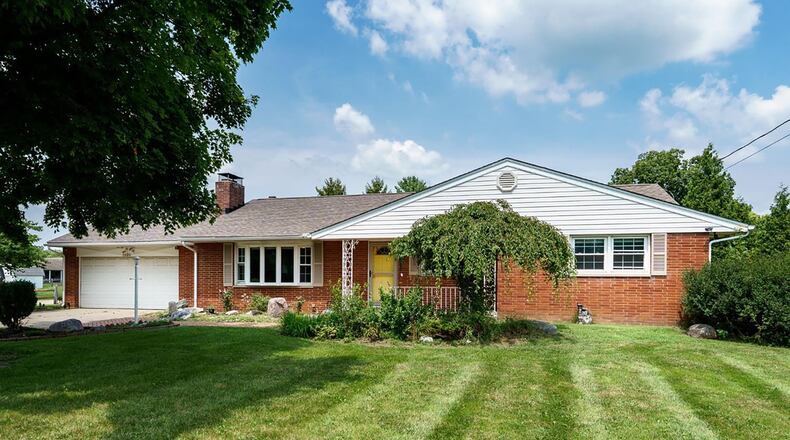 This 1960 brick ranch has been mostly updated and features hardwood flooring throughout, two woodburning fireplaces, three bedrooms and two full bathrooms and a partially finished basement. CONTRIBUTED