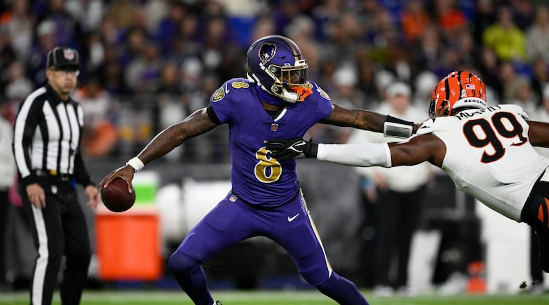 Baltimore Ravens quarterback Lamar Jackson (8) is pressures by Cincinnati Bengals defensive end Myles Murphy (99) during the second half of an NFL football game, Thursday, Nov. 7, 2024, in Baltimore. (AP Photo/Nick Wass)