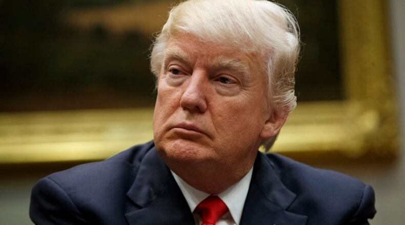 President Donald Trump listens during a meeting with the National Association of Manufacturers in the Roosevelt Room of the White House, Friday, March 31, 2017, in Washington. (AP Photo/Evan Vucci)