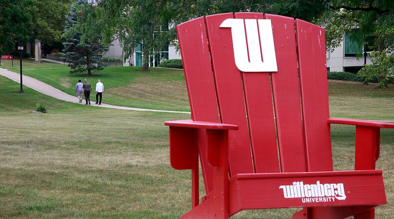 Three men walk across the campus of Wittenberg University Thursday, August 1, 2024. BILL LACKEY/STAFF