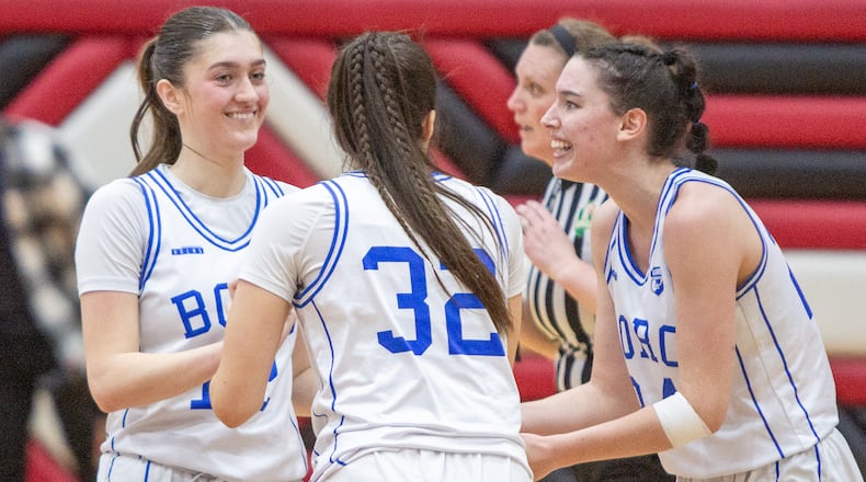 Springboro's Bryn Martin (left), Carly Turman (32) and Chloe Downing celebrate their 71-64 regional semifinal victory over Mason on Wednesday night at Lakota West High School. Jeff Gilbert/CONTRIBUTED