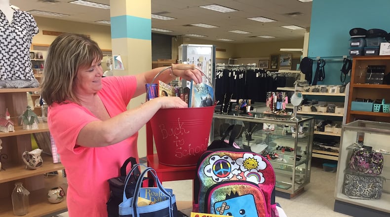 Wright-Patterson Air Force Base Thrift Shop Manager Paula Cardenas prepares a display of back-to-school items in preparation of the shop’s Aug. 17 reopening. (Skywrighter photo/Amy Rollins)