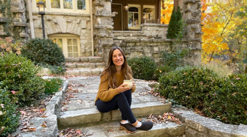 Sarena Kelley enjoys a cup of tea on the steps of her Oakwood home. Photo by Robin McMacken