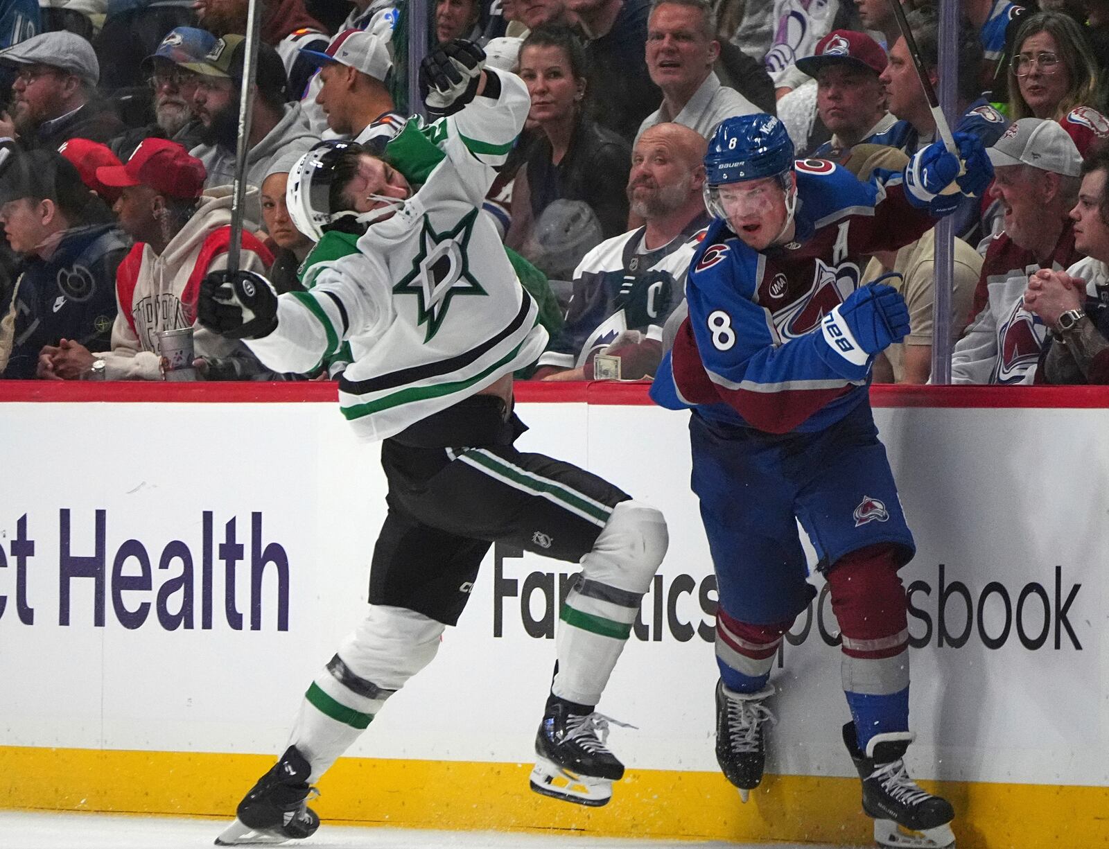 Dallas Stars left wing Mason Marchment, left, reacts after taking a check from Colorado Avalanche defenseman Cale Makar in the second period of Game 3 of an NHL hockey first-round playoff series Wednesday, April 23, 2025, in Denver. (AP Photo/David Zalubowski)
