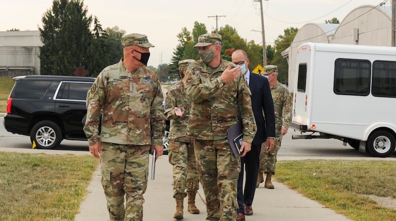 Col. Maurizio Calabrese, commander, National Air and Space Intelligence Center (NASIC), leads U.S. Space Force Gen. John "Jay" Raymond, left, chief of space operations, to NASIC for his day-long visit Sept. 24. Raymond is the senior military member of the U.S. Space Force. He serves as the principal advisor to the Secretary of the Air Force on Space Force activities. This is his first NASIC immersion since the creation of Space Force on December 20, 2019. (U.S. Air Force photo by Senior Airman Samuel Earick.)