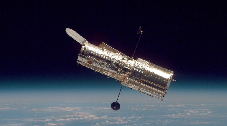 IN SPACE: (FILE PHOTO) In this handout from the National Aeronautical Space Administration, the Hubble Space Telescope drifts through space in a picture taken from the Space Shuttle Discovery during Hubble’s second servicing mission in 1997.
