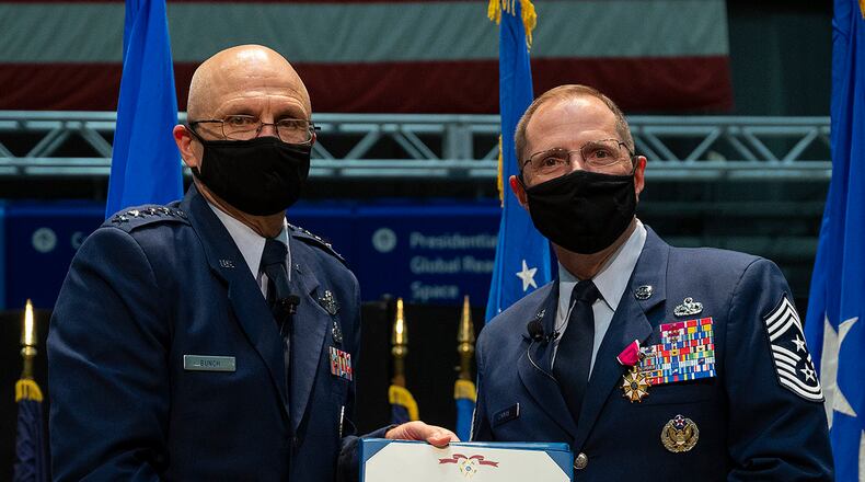 Gen. Arnold Bunch (left), commander of Air Force Materiel Command, presents the Legion of Merit to Chief Master Sgt. Stanley Cadell during the AFMC command chief’s retirement ceremony Oct. 1 in the National Museum of the U.S. Air Force. U.S. AIR FORCE PHOTO/R.J. ORIEZ