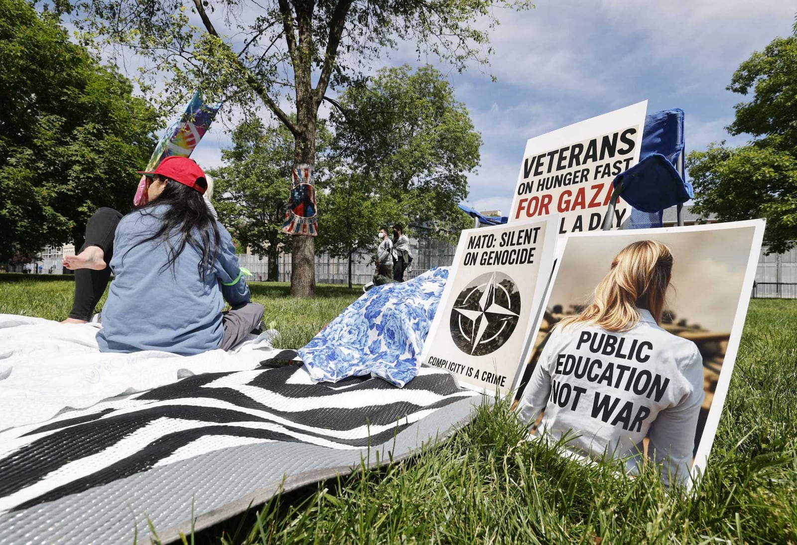 Protesters gathered at Cooper Park behind the Dayton Metro Library Main Branch down the street from the NATO Parliamentary Assembly happening in downtown Dayton on Saturday, May 24, 2025. NICK GRAHAM / STAFF