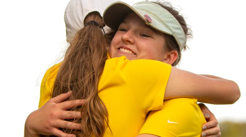 Alter sophomore Lauren Miller gets a hug from senior teammate Anna Sommers after winning the Division II district tournament Wednesday at Heatherwoode Golf Club. Jeff Gilbert/CONTRIBUTED