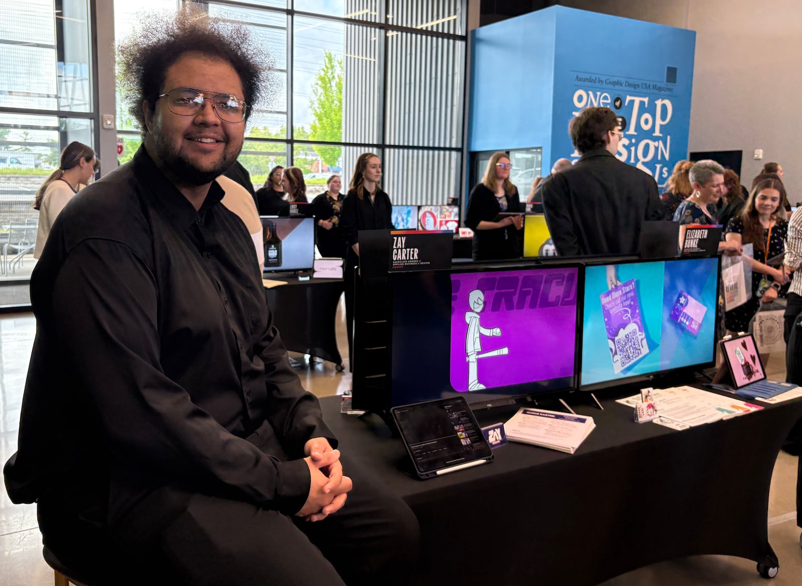 Zay Carter, a 2025 The Modern College of Design graduate, displays his digital portfolio during the annual "Reveal" showcase Friday, June 6, 2025, at the school's campus in Kettering. JEN BALDUF/STAFF