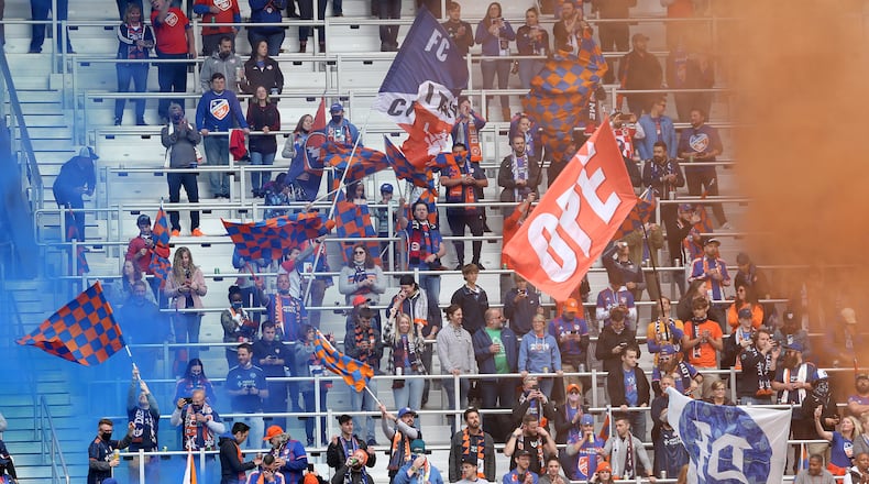 FC Cincinnati fans cheer on the team against the New England Revolution during the first half of an MLS soccer match, Saturday, May 29, 2021, at TQL Stadium in Cincinnati. (Kareem Elgazzar/The Cincinnati Enquirer via AP)