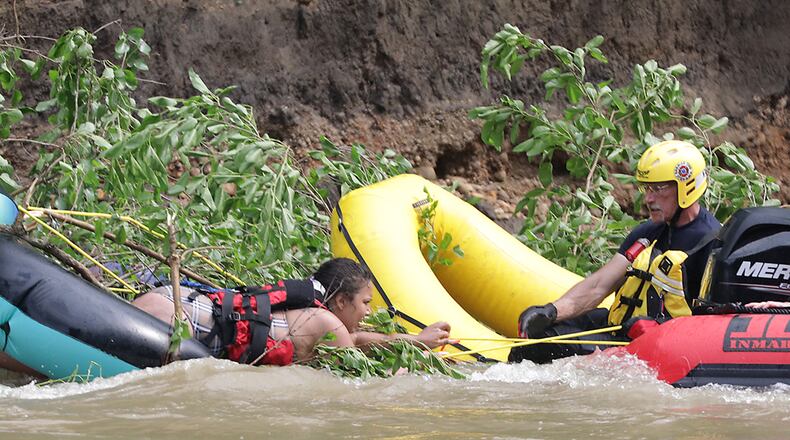 Four people had to be rescued from a fallen tree in the middle of the Mad River Monday, June 13, 2022. Fire departments from the City of Springfield, German Township and Mad River Township responded to the scene where four people had been tubing and became stranded in the swift moving water. German Township and Mad River Township used boats to rescue the victims, who were stranded between Eagle City Road and St. Paris Pike. BILL LACKEY/STAFF