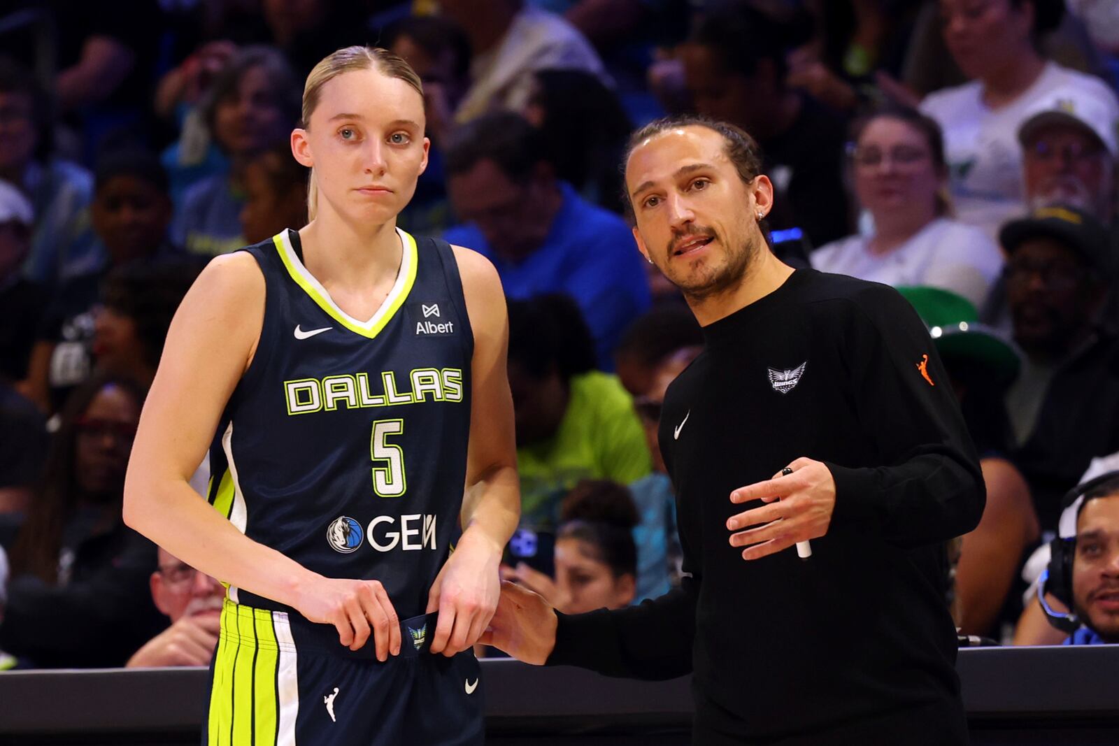 Dallas Wings guard Paige Bueckers (5) talks with head coach Chris Koclanes, right, in the first half of a WNBA basketball game against the Minnesota Lynx, Friday, May 16, 2020, in Arlington, Texas. (AP Photo/Richard W. Rodriguez)