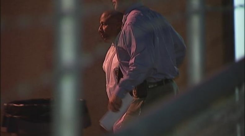 Officers take Floyd Palmer to the Fulton County Jail