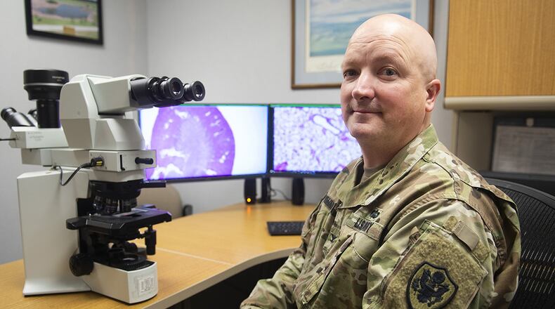 U.S. Army Col. Cary Honnold, Naval Medical Research Unit-Dayton comparative pathologist, poses in his NAMRU-D office on Wright-Patterson Air Force Base. Honnold crosses service lines by being an Army officer attached to a Navy unit on an Air Force base. (U.S. Air Force photo/R.J. Oriez)
