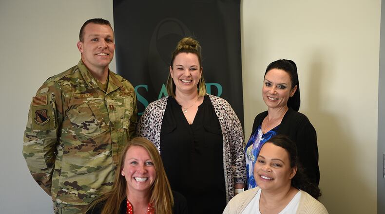 Wright-Patterson Air Force Base Sexual Assault Prevention and Response team members Capt. William Bolton (left), April Barrows, Annamae Willis, Kelly Hebert and Jazmyn Turner pose for a photo in their office May 12. The team won the 2021 Department of the Air Force Exceptional SAPR Team award for their effective and dedicated care for Wright-Patt Airmen. U.S. AIR FORCE PHOTO/AIRMAN 1ST CLASS JACK GARDNER