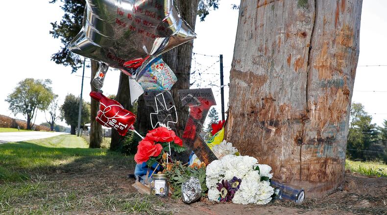 A roadside remembrance for Kendal “Kenny” DePhillip, a junior at Greenon High School, continues to grow along Fowler Road Tuesday. Bill Lackey/Staff