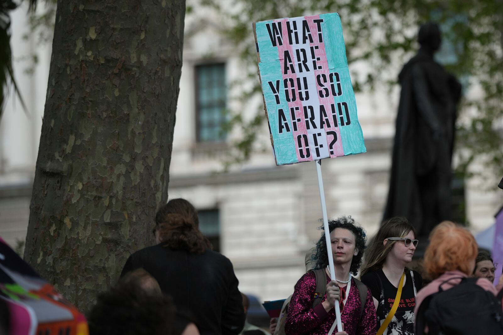 Campaigners take part in a rally organised by trans rights groups, trade unions, and community organisations following the Supreme Court ruling on the definition of a woman in equalities law, at Parliament Square, central London, Saturday April 19, 2025. (AP Photo/Alastair Grant)