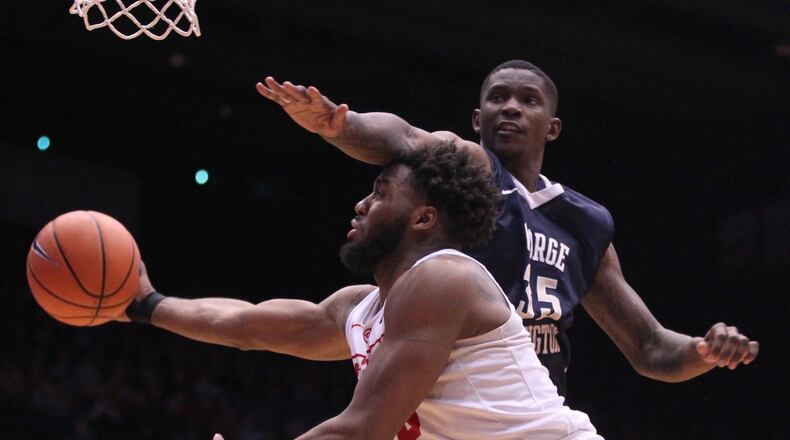 Dayton’s Josh Cunningham is fouled during a game against George Washington on Saturday, March 3, 2018, at UD Arena. David Jablonski/Staff