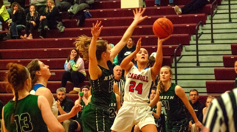 Carroll’s Allie Stefanek shoots over Hamilton Badin’s Maddie Thompson on Monday night at Lebanon High School . Carroll defeated Badin 40-22 to advance to Friday’s Division II district final at Mason. Jeff Gilbert/CONTRIBUTED