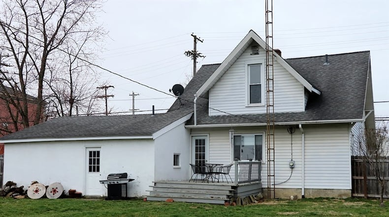 A nook off the kitchen has built-in storage cabinet, access to the rear wooden deck and back yard. A privacy fence surrounds the back yard.