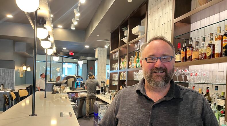 Shane Anderson, owner of Ghostlight Coffee, at Gather by Ghostlight at the Dayton Arcade. Ghostlight Coffee is among eight local businesses on Midwestern Traveler magazine's Best in Ohio list. CORNELIUS FROLIK / STAFF