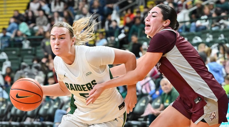 Wright State senior guard Claire Henson dribbles with pressure from Bellarmine's Ava Smith during a game on Wednesday, Nov. 19 at the Nutter Center. Henson, a Valley View graduate, scored 13 points and had 12 rebounds and four assists. BRYANT BILLING/STAFF