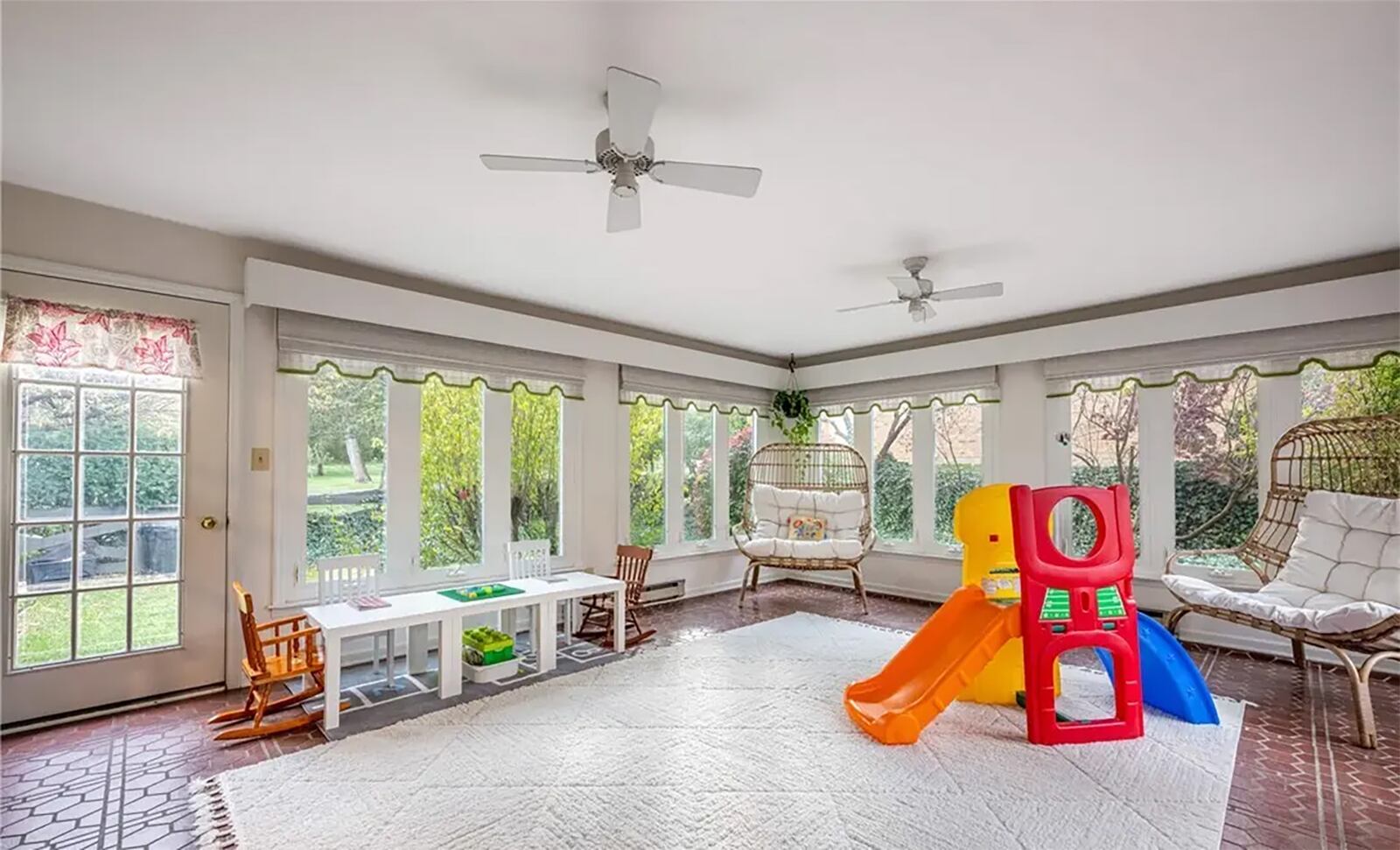The sunken sunroom has tile floors, two ceiling fans and two exterior doors. CONTRIBUTED