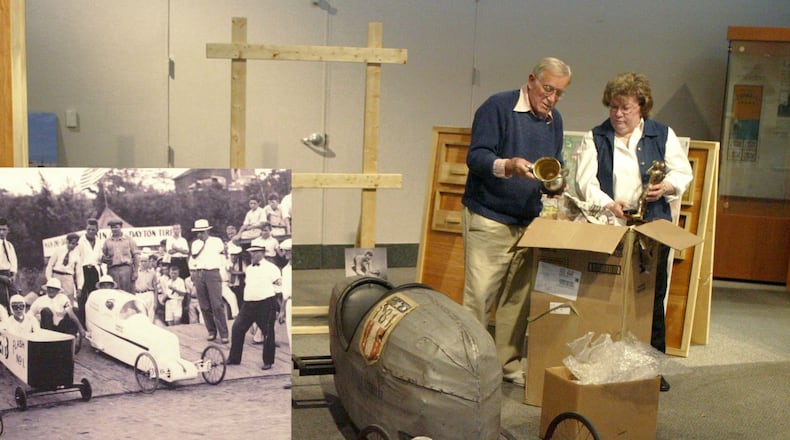 Skip Ordeman and Nancy Horlacher unpack trophies in 2005 from the Soap Box Derby. The racer on their left was the winner of the 1935 race. DDN FILE PHOTO