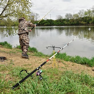 Nick Griffith fishes along the bank of the Great Miami River at Combs Park in Hamilton. STAFF FILE PHOTO/2016