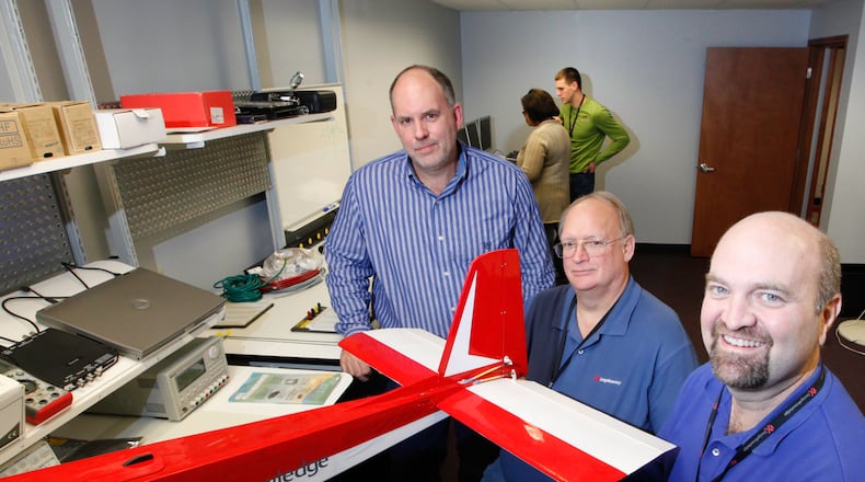 From a 2013 file photo, The DesignKnowledge Co. principals seen here are (from left): Eric Loomis, vice president and owner, James McCracken, founder, vice president and owner, and Daniel Schiavone, president. They’re showing a company drone used to gather data. CHRIS STEWART / STAFF