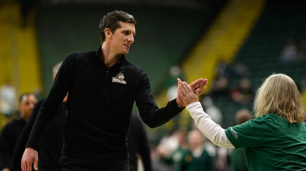 Wright State University men's basketball coach Clint Sargent high fives a fan during their game against IU Indy on Thursday, Feb. 19, 2026 at the Nutter Center. JEREMY MILLER / CONTRIBUTED PHOTO