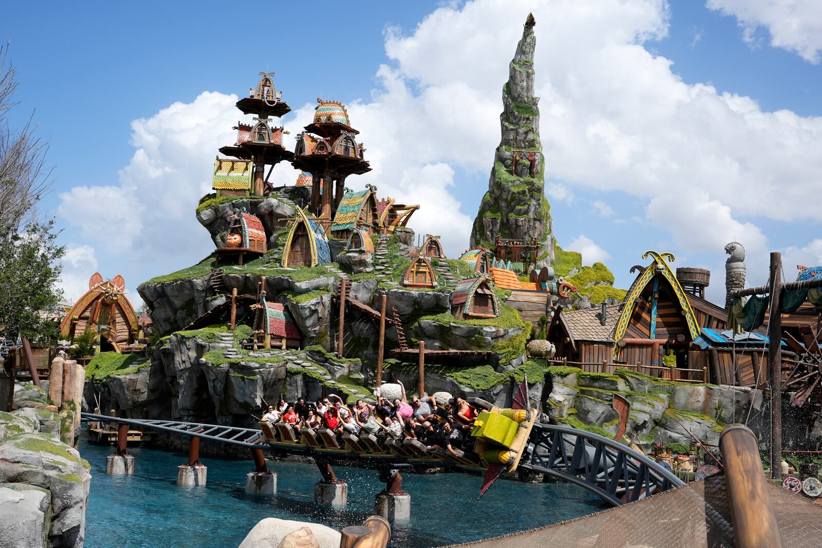 Guest ride a roller coaster in the How To Train Your Dragon – Isle Of Berk at Epic Universe theme park at Universal Resort Orlando Thursday, April 10, 2025, in Orlando, Fla. (AP Photo/John Raoux)