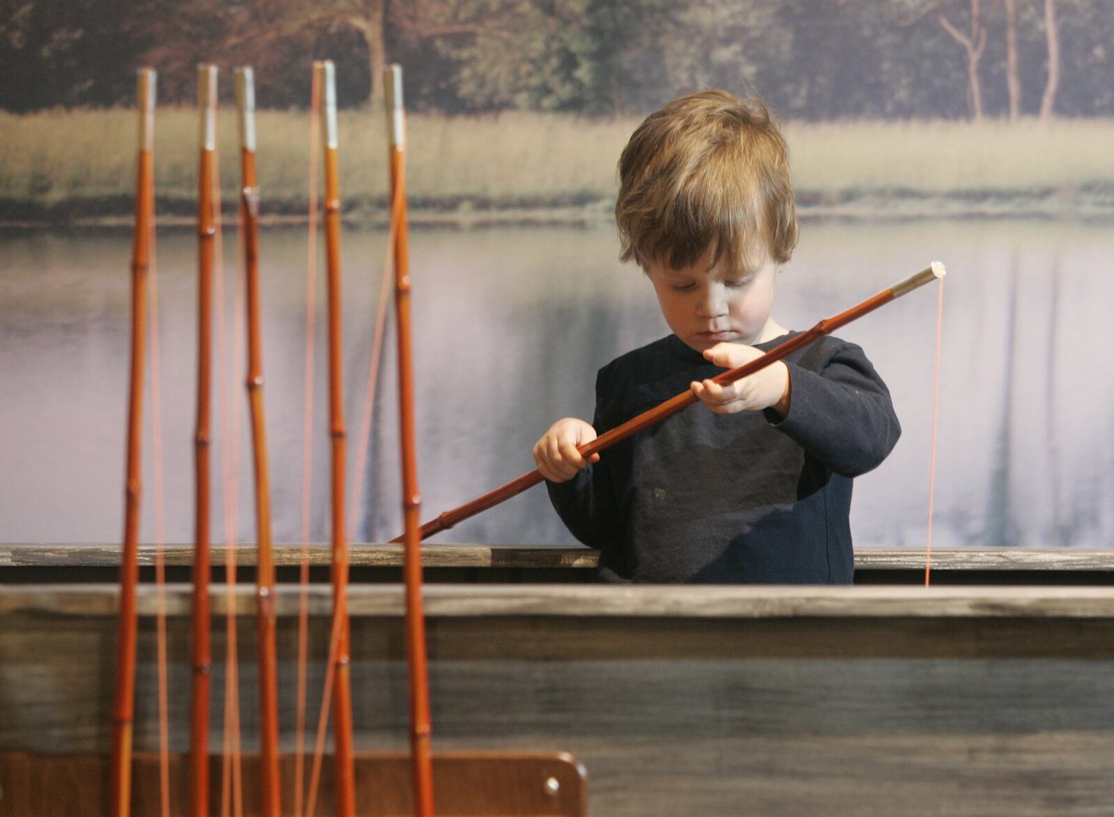 A child plays in the fishing boat at AHA!, A Hands-on Adventure, a children’s museum in Lancaster. ANDREA KJERRUMGAARD/THE COLUMBUS DISPATCH