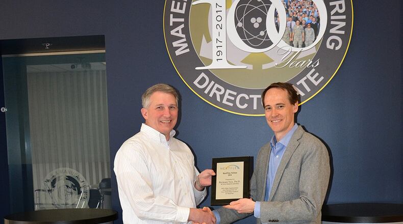 Dr. Richard Vaia (left), technical director, in the Air Force Research Laboratory’s Materials and Manufacturing Directorate, was one of six people selected to receive the NextFlex Fellow award. Vaia is congratulated by Dr. Benjamin Leever, senior materials engineer and government chief technology officer of NextFlex. (U.S. Air Force photo/Karen Schlesinger)
