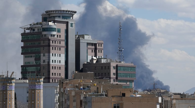 Smoke rises up after a strike in Tehran, Iran, Sunday, March 1, 2026. (AP Photo/Vahid Salemi)