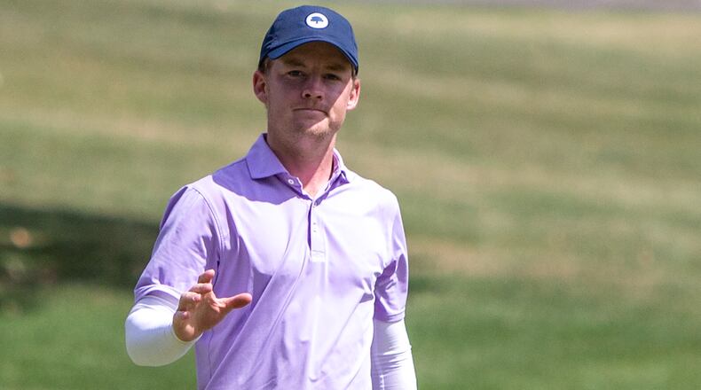 Tyler Goecke acknowledges the applause after making a long putt on No. 18 to finish his victory in the 102nd Metro at Miami Valley Golf Club earlier this summer. Jeff Gilbert/CONTRIBUTED