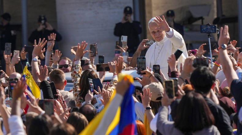 Pope Leo XIV tours on his popemobile after presiding over a Mass in St. Peter's Square at the Vatican during which he canonized seven new saints of the Catholic Church, Sunday, Oct. 19, 2025. (AP Photo/Andrew Medichini)