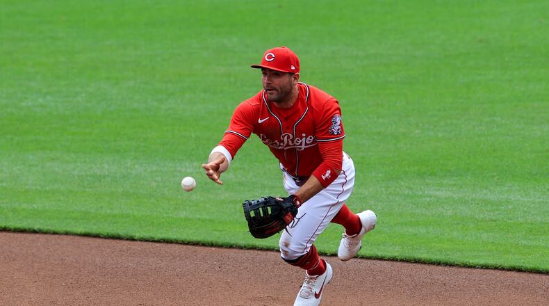 Cincinnati Reds' Joey Votto fields the ball and throws to first base during the first inning of a baseball game against the Chicago White Sox in Cincinnati, Wednesday, May 5, 2021. (AP Photo/Aaron Doster)
