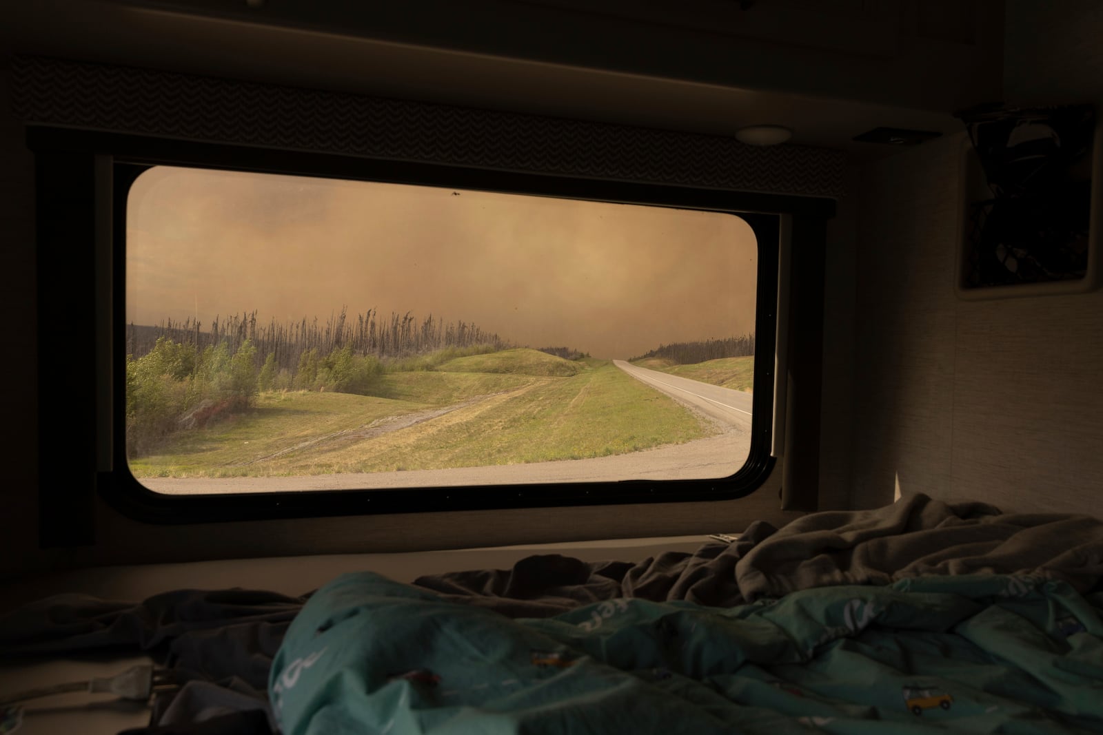 Wildfire smoke hangs in the air above Highway 97 north of Buckinghorse River, British Columbia, on Friday, May 30, 2025. (Nasuna Stuart-Ulin/The Canadian Press via AP)