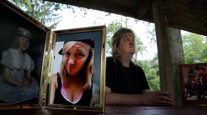 Sandy Hinkle of Troy holding a photo of her daughter, Kaitlyn Cruea, who overdosed and died in 2016 in Palm Beach County. BYRON STIRSMAN/STAFF