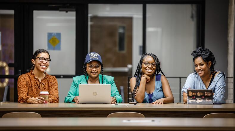 From left, Taylor Johnson, Jameelah Ricks, Whitney Barkley and Dawn Turner chat in The Hub Powered by PNC Bank at the Arcade in downtown Dayton. Johnson, Ricks and Turner are all Greater West Dayton Incubator fellows. Barkley is incubator director. The incubator assists entrepreneurs and small businesses. The new Dayton Region Economic Development Strategy prioritizes entrepreneurship and small business and sets equity goals. JIM NOELKER/STAFF