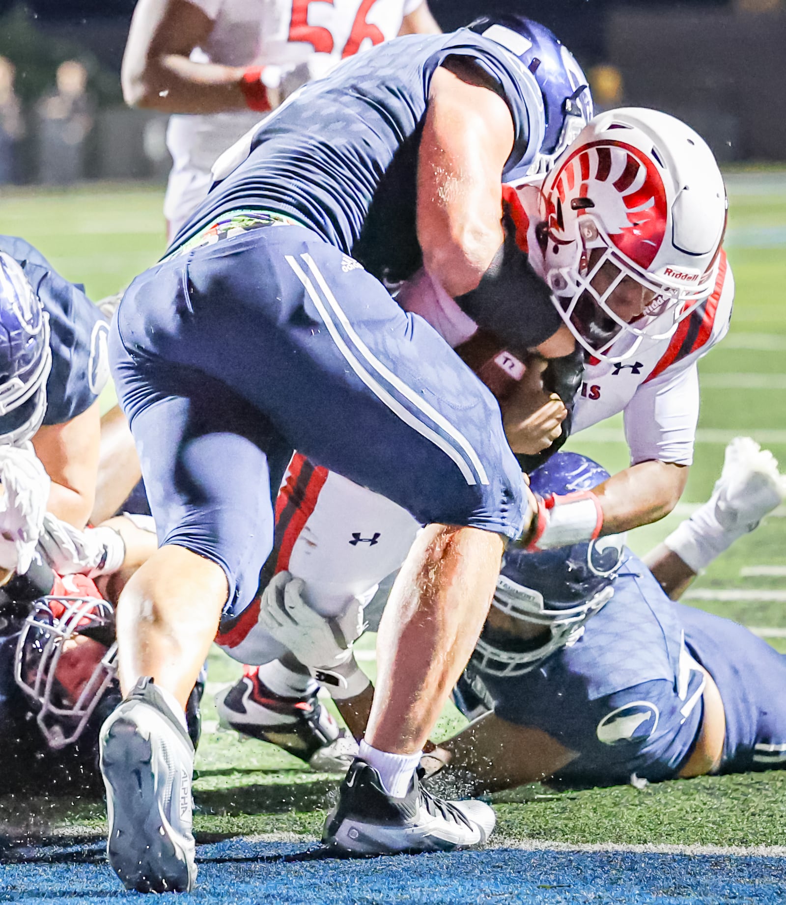 Trotwood-Madison senior quarterback Dallas Shehee scores on a two-point conversion as Fairmont's Skyler Slifer tries to prevent him from crossing the goal line during a nonconference game on Friday, Aug. 29 at Roush Stadium in Kettering. BRYANT BILLING / STAFF