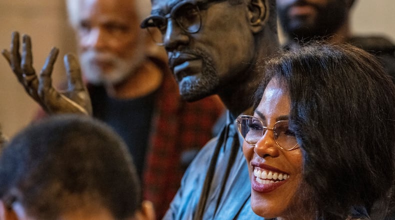 Ilyasah Shabazz poses for a photo of the bust of her father, Malcolm X, after he was inducted into the Nebraska Hall of Fame during a ceremony in the Warner Legislative Chamber in Lincoln, Neb., on Wednesday, May 22, 2024. (Chris Machian/Omaha World-Herald via AP)