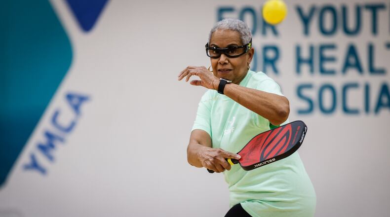 Retiree Carolyn White plays pickle ball with other seniors at the Kleptz Branch of the YMCA in Englewood. JIM NOELKER/STAFF