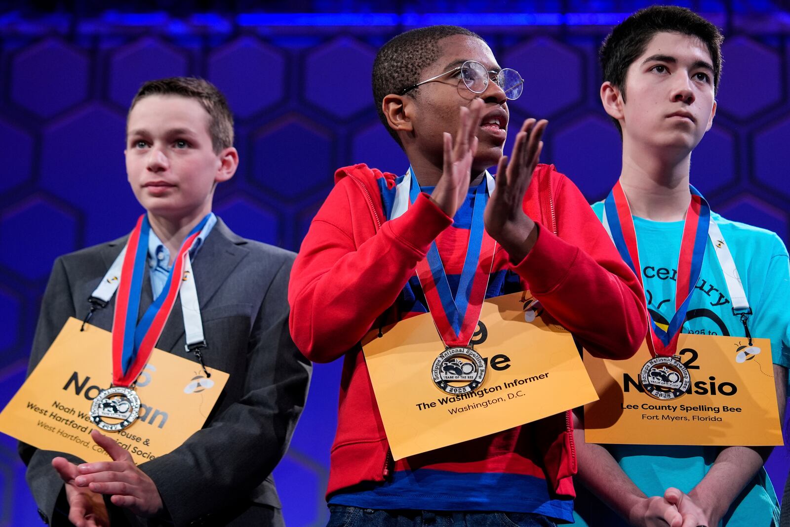 Zwe Sunyata Spacetime, 13, of Washington, center, applauds following the quarterfinals of the Scripps National Spelling Bee, Wednesday, May 28, 2025, in Oxon Hill, Md. (AP Photo/Julia Demaree Nikhinson)