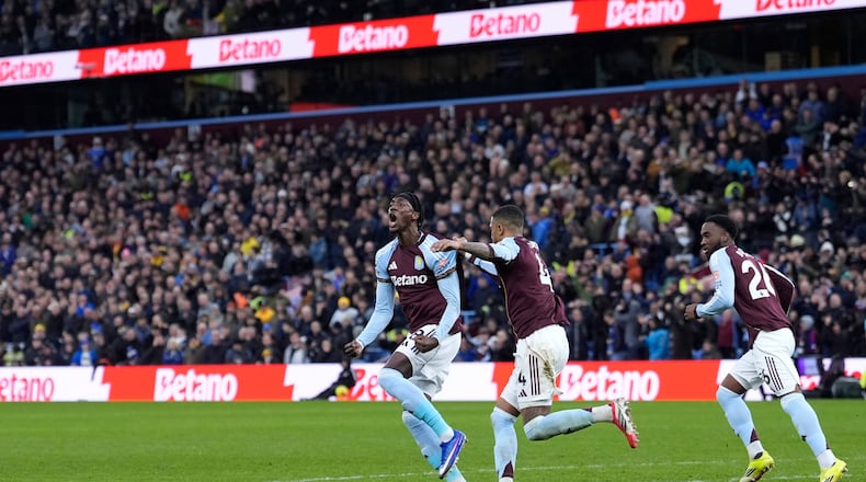 Aston Villa's Tammy Abraham celebrates scoring their side's first goal of the game during their English Premier League soccer match against Leeds United in Birmingham, England, Saturday, Feb. 21, 2026. (Peter Byrne/PA via AP)