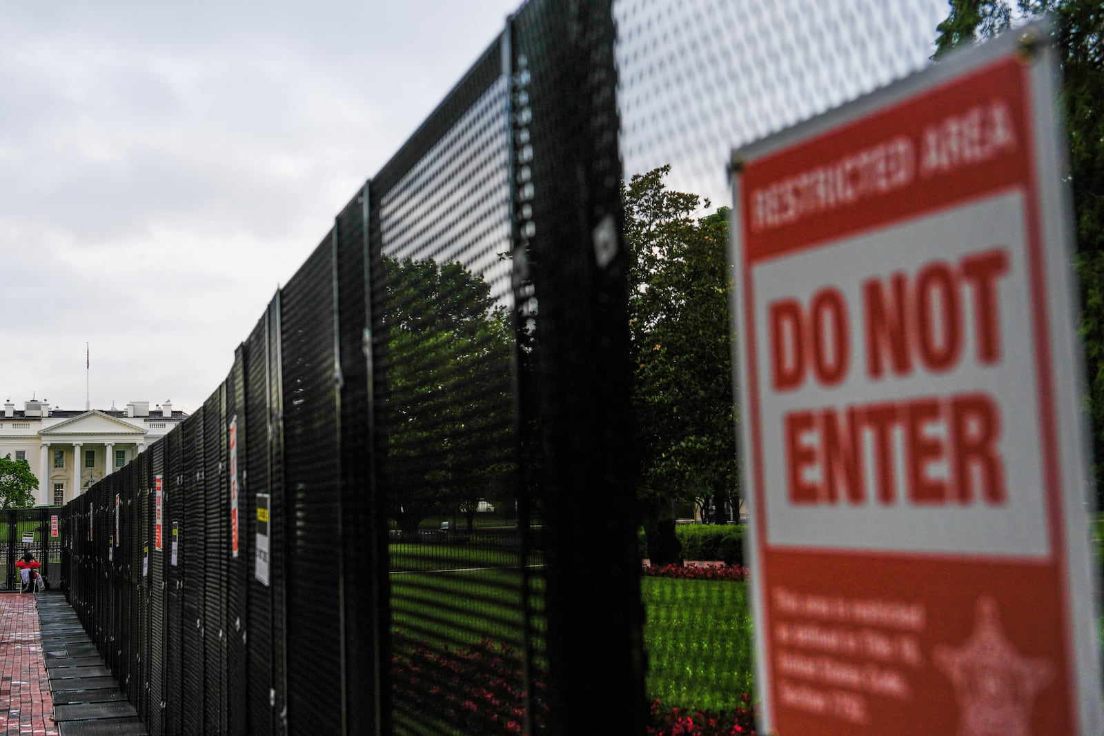 A fence blocks access to the White House ahead of an upcoming military parade commemorating the U.S. Army's 250th anniversary and coinciding with President Donald Trump's 79th birthday, Saturday, June 14, 2025, in Washington (AP Photo/Julia Demaree Nikhinson)