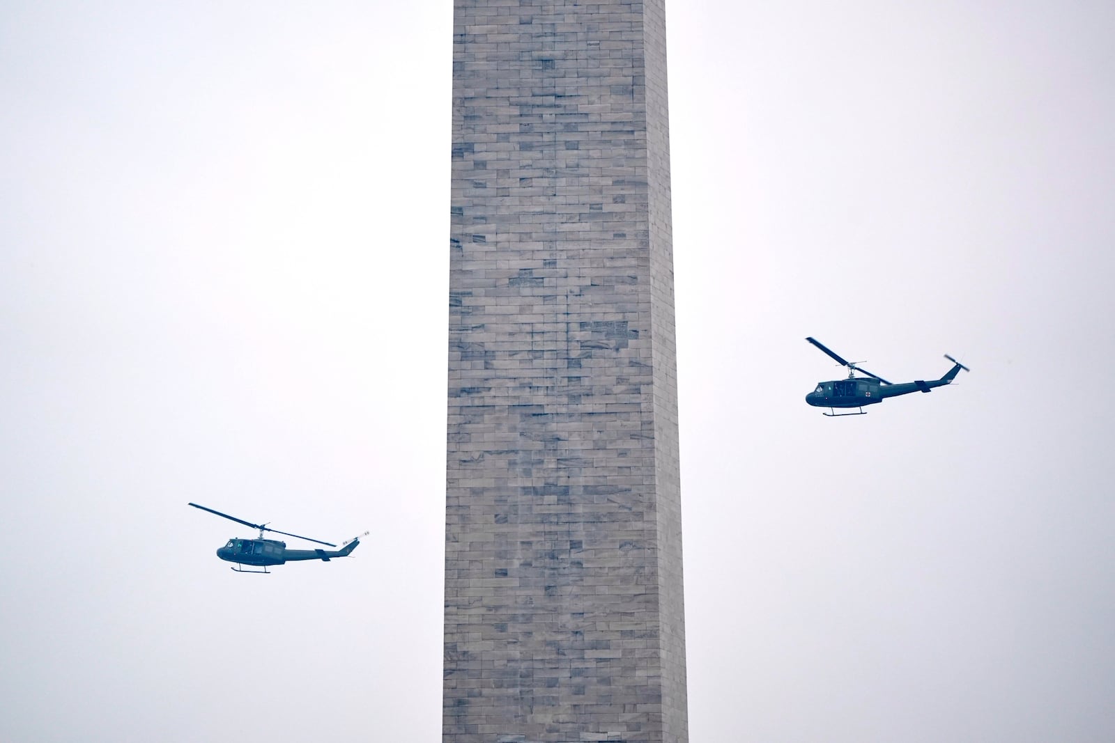 U.S. Army UH-60M Black Hawk helicopters perform a flyover during an event to honor the Army's 250th anniversary, coinciding with President Donald Trump's 79th birthday, Saturday, June 14, 2025, in Washington. (AP Photo/Mark Schiefelbein)